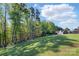 Large backyard features lawn, landscaping and mature trees, creating a private outdoor oasis at 164 Riverstone Dr, Davidson, NC 28036