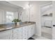Bright bathroom features a granite countertop, white cabinets, and a double sink at 164 Riverstone Dr, Davidson, NC 28036