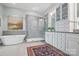 Beautiful bathroom features a soaking tub, glass-enclosed shower, and double vanity with stone countertops at 164 Riverstone Dr, Davidson, NC 28036