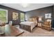 Comfortable bedroom with a wooden bed frame, neutral tones, and natural light at 164 Riverstone Dr, Davidson, NC 28036