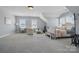 Spacious bedroom features lots of natural light, sitting area, and a desk for work or study at 164 Riverstone Dr, Davidson, NC 28036