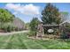 Anniston community sign surrounded by beautiful flowers and lush greenery, creating a welcoming entrance to the neighborhood at 164 Riverstone Dr, Davidson, NC 28036