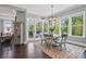 Bright dining room features a round table with seating for six, large windows and access to the back deck at 164 Riverstone Dr, Davidson, NC 28036