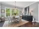 Elegant dining room featuring a round table with seating for six and beautiful backyard views at 164 Riverstone Dr, Davidson, NC 28036