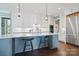 Well-lit kitchen features a large island with barstool seating, stainless steel appliances and white cabinetry at 164 Riverstone Dr, Davidson, NC 28036