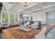 Bright and airy living space featuring coffered ceilings, hardwood floors, and seamless transition to the kitchen at 164 Riverstone Dr, Davidson, NC 28036