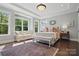 Spacious main bedroom with lots of natural light, a sitting area, and decorative rug on hardwood floors at 164 Riverstone Dr, Davidson, NC 28036