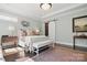 Bright main bedroom featuring neutral walls, beautiful rug on hardwood floors and lots of natural light at 164 Riverstone Dr, Davidson, NC 28036