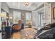 Comfortable home office with natural light, coffered ceilings, a stylish desk, and relaxing massage chair at 164 Riverstone Dr, Davidson, NC 28036