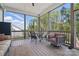 Screened-in porch with wooden floors and a table and chairs to enjoy outdoor living at 164 Riverstone Dr, Davidson, NC 28036
