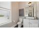 Stylish powder room featuring modern fixtures, a vanity, and a well-lit window at 164 Riverstone Dr, Davidson, NC 28036