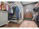 Large walk-in closet featuring custom shelving, hardwood floors, and an area rug at 164 Riverstone Dr, Davidson, NC 28036