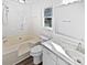 Bright bathroom with a tub, vanity and natural light coming from the window at 1727 Running Brook Rd, Charlotte, NC 28214