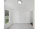 A bedroom with neutral walls, carpeted floors, a window, and two doors at 1727 Running Brook Rd, Charlotte, NC 28214