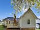 A well-maintained backyard with a deck and view of the home's architecture at 1727 Running Brook Rd, Charlotte, NC 28214