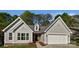 Home featuring a well-manicured lawn, attached two-car garage, and neutral-toned siding at 1727 Running Brook Rd, Charlotte, NC 28214