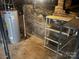 Unfinished basement area showing brick foundation walls, storage shelves, and a hot water heater at 2221 Commonwealth Ave, Charlotte, NC 28205