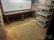 Unfinished basement with workbench, storage shelves, and concrete floor at 2221 Commonwealth Ave, Charlotte, NC 28205