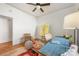Bedroom featuring hardwood floors, ceiling fan, and large window at 2221 Commonwealth Ave, Charlotte, NC 28205