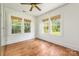 Bright, airy bedroom with three large windows and hardwood flooring at 2221 Commonwealth Ave, Charlotte, NC 28205