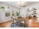 Bright dining room with hardwood floors, chandelier, and large windows at 2221 Commonwealth Ave, Charlotte, NC 28205