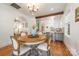 Dining room showcasing hardwood floors, chandelier, and open access to the kitchen at 2221 Commonwealth Ave, Charlotte, NC 28205