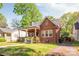Charming brick home with a cozy front porch and well-maintained landscaping at 2221 Commonwealth Ave, Charlotte, NC 28205