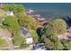 Aerial view of lakeside home with private docks and mature trees, highlighting the lake lifestyle at 235 Commodore Loop, Mooresville, NC 28117