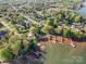 Aerial view showcasing a waterfront community with private docks and mature trees, ideal for lake living at 235 Commodore Loop, Mooresville, NC 28117