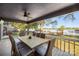 Relaxing back porch with outdoor dining set and beautiful views of the serene lake and its dock at 235 Commodore Loop, Mooresville, NC 28117