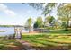 Scenic view of a backyard with a stone walkway leading to a gazebo and dock on the lake at 235 Commodore Loop, Mooresville, NC 28117
