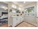 Bright bathroom with double vanity, updated fixtures, a window, and an ensuite bedroom view at 235 Commodore Loop, Mooresville, NC 28117