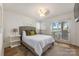 Bright bedroom featuring a serene lake view and sliding glass doors for seamless outdoor access at 235 Commodore Loop, Mooresville, NC 28117