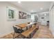 Bright dining area with a wooden table and bench seating next to the kitchen at 235 Commodore Loop, Mooresville, NC 28117