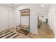 Inviting foyer featuring modern coat rack and bench with an open view to the dining and living areas at 235 Commodore Loop, Mooresville, NC 28117