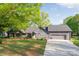 Charming single-story home with a well-manicured lawn, attached garage, and inviting front entrance at 235 Commodore Loop, Mooresville, NC 28117