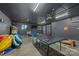 Finished basement game room with ping pong table, television, and lake toys for recreation and entertainment at 235 Commodore Loop, Mooresville, NC 28117