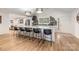 Open kitchen with a large island, stainless steel appliances, and a view of the entrance at 235 Commodore Loop, Mooresville, NC 28117