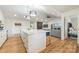 Bright, modern kitchen with island seating, stainless appliances, and open design to the living room and bedroom at 235 Commodore Loop, Mooresville, NC 28117