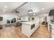 Modern kitchen featuring a center island, stainless steel appliances, and an open layout to the living room at 235 Commodore Loop, Mooresville, NC 28117