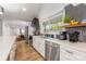 Bright kitchen features stainless steel appliances, modern countertops, and wood-look flooring at 235 Commodore Loop, Mooresville, NC 28117