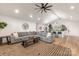 Open concept living room with modern décor, ceiling fan, and seamless flow to the kitchen and dining areas at 235 Commodore Loop, Mooresville, NC 28117