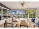 Sunroom featuring comfortable seating, large windows with lake views, and a tranquil atmosphere at 235 Commodore Loop, Mooresville, NC 28117