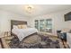Tranquil main bedroom with a large bed, rug, and sliding doors with access to the backyard at 235 Commodore Loop, Mooresville, NC 28117