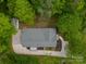Aerial view of the house featuring roof, driveway, and lush surrounding trees at 2646 Jacobs Rd, Gastonia, NC 28054
