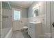 Charming bathroom featuring subway tile surround, classic vanity, and patterned tile flooring at 2646 Jacobs Rd, Gastonia, NC 28054