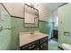 This retro bathroom features tile walls, a vanity with sink, and a mirror at 2646 Jacobs Rd, Gastonia, NC 28054