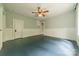 Spacious bedroom featuring a ceiling fan, painted wood floors, and bright, natural light at 2646 Jacobs Rd, Gastonia, NC 28054