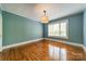 Well lit bedroom featuring hardwood flooring, neutral paint, and a large window at 2646 Jacobs Rd, Gastonia, NC 28054