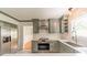 The renovated kitchen has gray cabinets, stainless appliances, and hardwood floors at 2646 Jacobs Rd, Gastonia, NC 28054